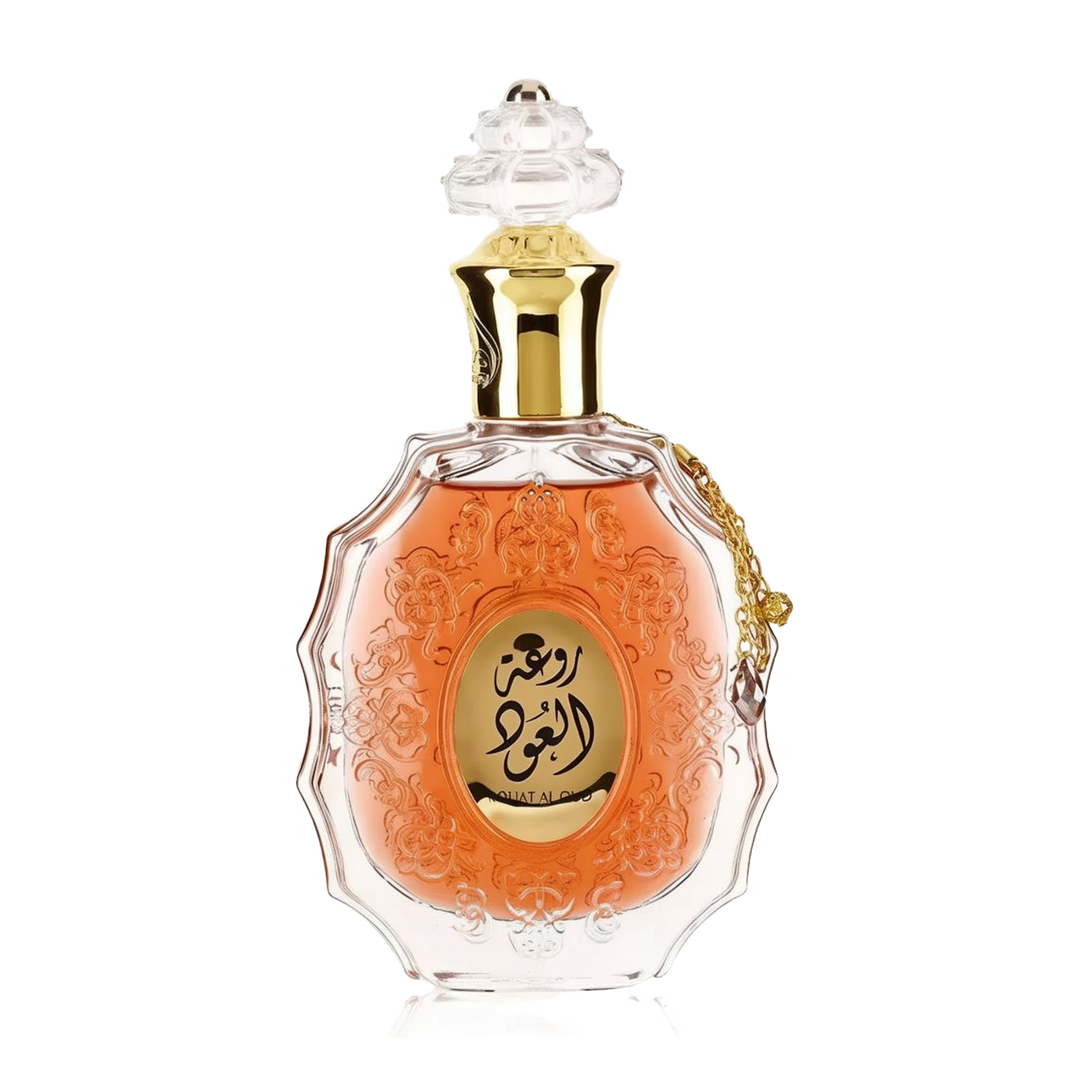 he image features an ornate perfume bottle: The bottle is made of clear glass with a decorative texture and a central amber-colored panel. A clear and intricate glass stopper tops the bottle. A golden metallic chain with a charm is attached to the neck of the bottle. Arabic calligraphy is featured within the amber panel, and the name "ROUAT AL OUD" is inscribed in English below the calligraphy.
