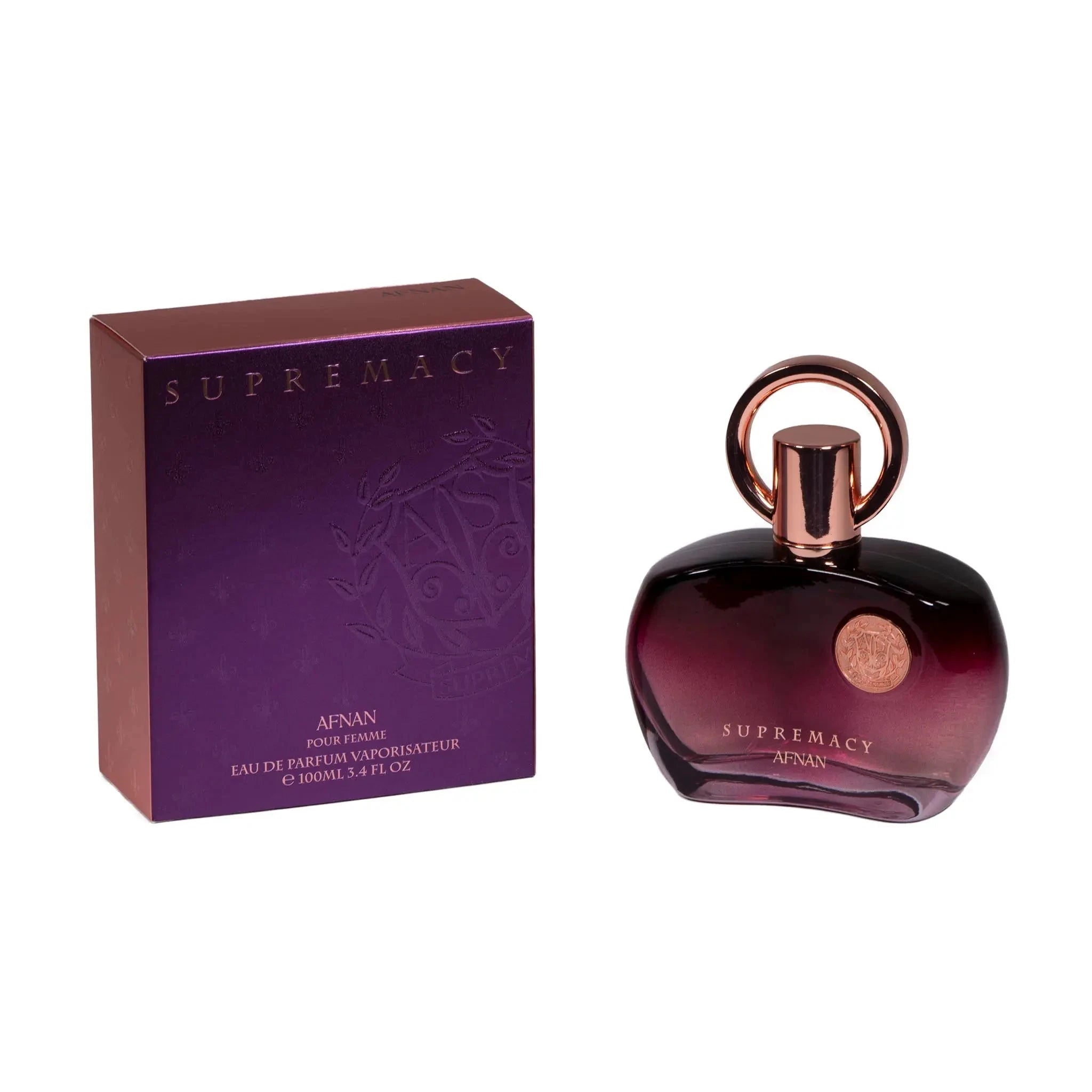 The image displays a perfume set which includes a bottle and its packaging box. The bottle has a dark purple gradient color with a glossy finish and a rose gold cap with a loop design on top. Next to the bottle is its box, in a matching purple shade with metallic sheen, and the brand and perfume name embossed on it. The box specifies that it is for women and contains "Eau de Parfum Vaporisateur" of 100ml or 3.4 fl oz. The overall presentation is elegant and suggests a luxurious fragrance product.
