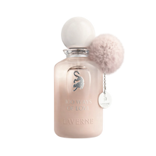 Soft beige perfume bottle with round cap, cat emblem, and fluffy pom pom charm labelled “100 Ways of Love”.