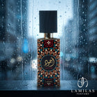 Lattafa Ajwad perfume bottle with an ornate colorful label, displayed on a wet surface against a rainy window.
