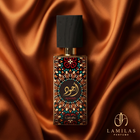 Lattafa Ajwad perfume bottle featuring a detailed colorful geometric label and black cap, set against luxurious bronze silk draping.
