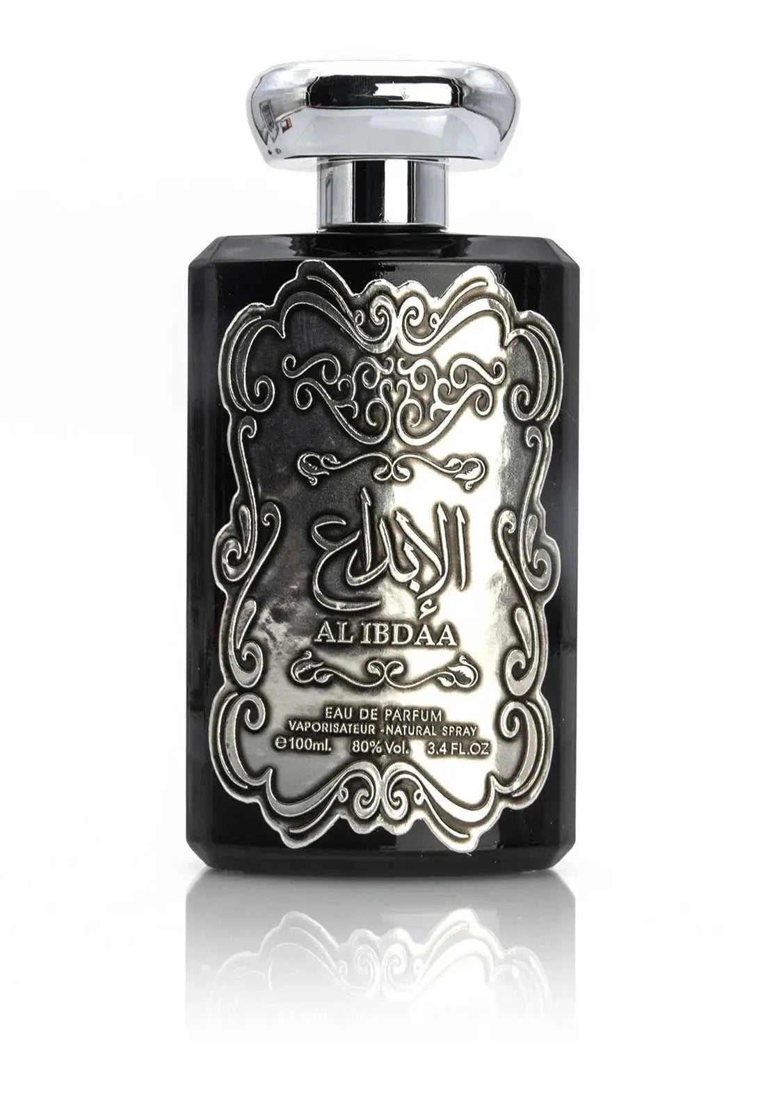 The image features a black perfume bottle with a detailed silver embossed design on the front. The central design includes Arabic calligraphy that reads 'AL IBDAA', likely the name of the fragrance. Below the calligraphy, in smaller English text, it states 'EAU DE PARFUM', 'VAPORISATEUR NATURAL SPRAY', '100ml', '80% VOL', and '3.4 FL.OZ', which describe the product type, dispensing method, volume, alcohol content, and fluid ounces, respectively. 