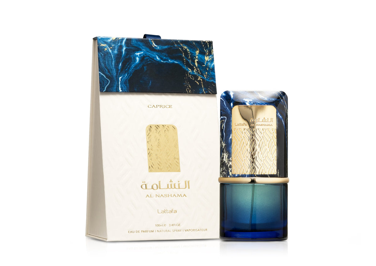 A deep-blue glass perfume bottle with a decorative gold band and a marbled blue-and-gold rectangular cap stands beside a matching white box. The box features a raised pattern, gold accents, and navy-blue marbling at the top, with the product name “Al Nashama” and “Lattafa” printed in gold.