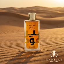 Ameer Al Oudh Intense Oud perfume bottle by Lattafa, featuring a gold cap, placed on golden sand dunes at sunset.