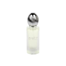  The image shows a frosted glass perfume bottle with a metallic, ribbed cap. The bottle has text in Arabic and English that reads "ANA ABIYEDH" indicating the fragrance name. The design is minimalist and modern, and the translucency of the bottle suggests a light or fresh scent, likely intended as a hair mist, as indicated by the product's volume labeled at the bottom "50ml."