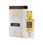 A perfume box and bottle set for 'Ana Abiyedh Leather' by Lattafa. The box is white with gold and black accents, featuring Arabic and English text that reads 'I Am White' in embossed letters. The bottle is clear with a gold label and a square gold cap ado