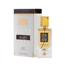 A perfume box and bottle set for 'Ana Abiyedh Leather' by Lattafa. The box is white with gold and black accents, featuring Arabic and English text that reads 'I Am White' in embossed letters. The bottle is clear with a gold label and a square gold cap ado