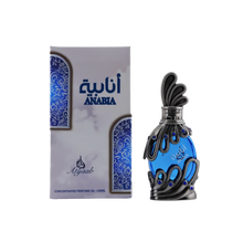 A vivid blue glass bottle of Anabia concentrated perfume oil by Khadlaj encased in an ornate silver filigree design with small blue accents and topped with a sculpted silver cap, shown alongside its matching box decorated with swirls in complementary shades of blue and silver.
