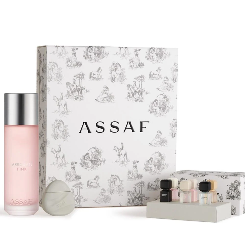 Assaf Arrogate Pink fragrance gift set with large pink bottle, mini perfumes, and decorative white box.