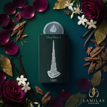 Lattafa Art of Arabia I perfume box featuring a silver Burj Khalifa, framed by oud chips, vanilla, rose, and jasmine.