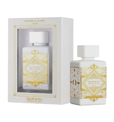 The image displays a perfume package by Lattafa for the fragrance "HONOR & GLORY Badee Al Oud". It includes a white rectangular box with a display window and a bottle outside of the box for a clearer view. The box and bottle are adorned with elegant gold 