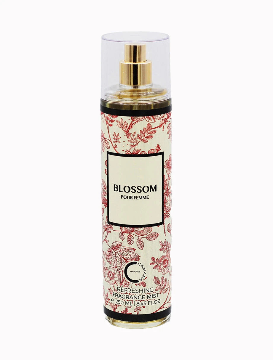 The image is of a product labeled "Blossom Pour Femme" by Camara. It is a refreshing fragrance mist in a clear, cylindrical bottle with a spray nozzle and a transparent cap. The bottle contains 250 ml (8.45 fl. oz) of the product. The label has an elegant