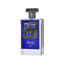 Lattafa Pride Blue Sapphire perfume bottle featuring a dark blue label, clear glass, and a prominent gunmetal plate with three blue square gems.lattafa-pride-blue-sapphire-perfume-bottle.jpg
