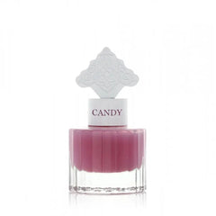  The image features a perfume bottle with a clear base and a purple-colored liquid. It has a white cap with the word "CANDY" printed on it in purple, matching the liquid's color. The cap is topped with a white ornate design that resembles an intricate architectural pattern, possibly inspired by Middle Eastern art.