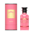 A pink, cylindrical perfume box with a gold-accented Luxe Vision Chant On You label beside a matching pink glass perfume bottle adorned with a decorative gold motif