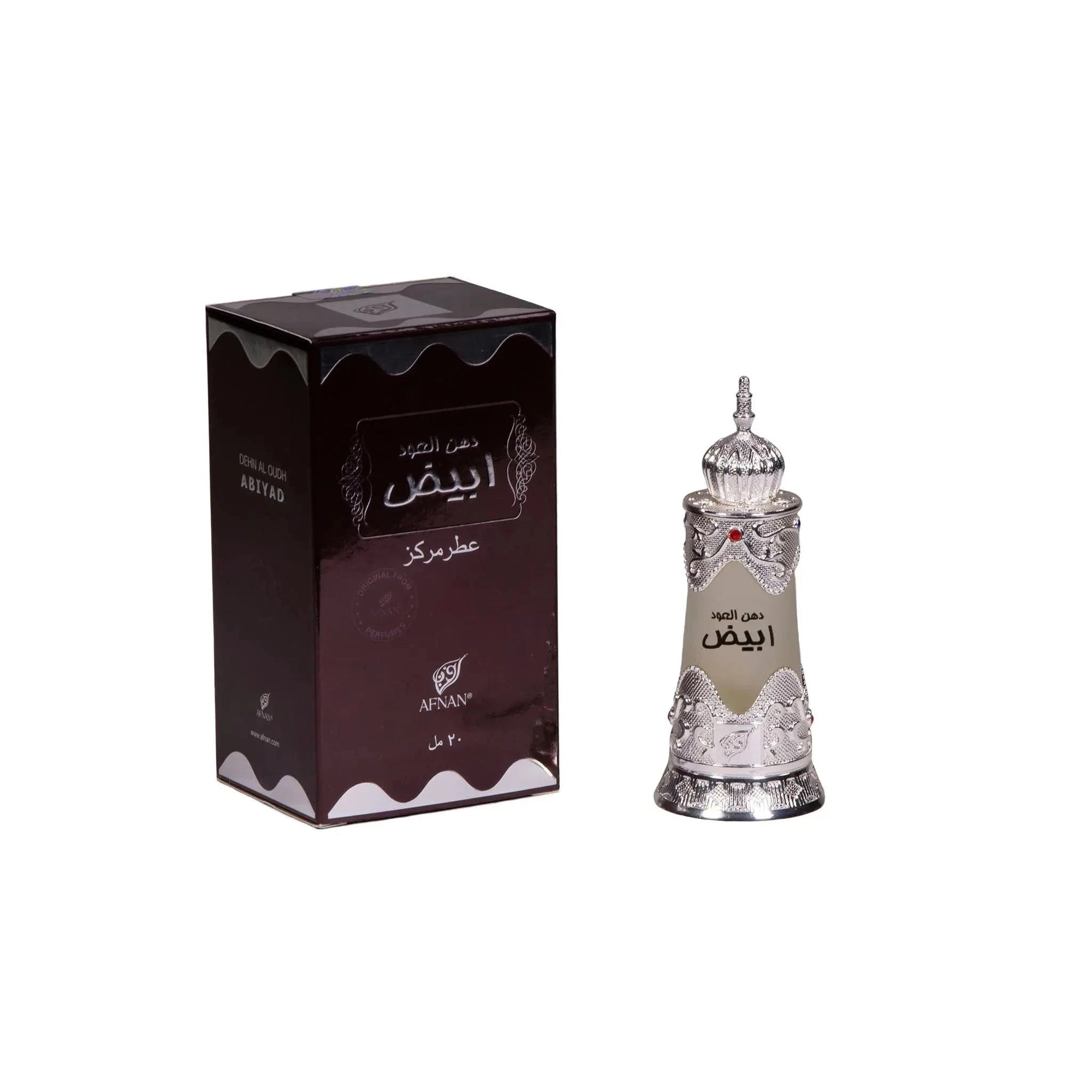 The image shows a set of Arabic perfume products, including a box and a bottle. The box is dark brown with a glossy finish and features intricate white and gold detailing, including Arabic calligraphy that reads "?????" (Al Oud), which suggests that the perfume is of the Oud fragrance variety. The brand name "AFNAN" is also visible on the box. Beside the box stands an ornate perfume bottle, similar to the one described earlier, with intricate silver filigree work and a frosted glass center. 
