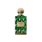 A luxurious bottle of Emerald Oud perfume by Ibraheem Al-Qurashi, featuring a geometric emerald green glass design with reflective triangular facets. The bottle is topped with a textured, spherical gold cap and has a gold nameplate on the front engraved with 'Emerald Oud' in elegant script along with Arabic text and branding. A solid gold base completes the opulent look, conveying a rich and sophisticated aesthetic.