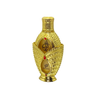 The image shows a luxurious perfume bottle from the brand "Afnan." The bottle has an opulent design featuring a gold exterior adorned with intricate beading and decorative elements. The front of the bottle has two teardrop-shaped windows revealing the amber-colored perfume inside, with the brand name "Afnan" and elegant Arabic calligraphy.