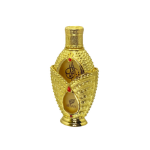 The image shows a luxurious perfume bottle from the brand "Afnan." The bottle has an opulent design featuring a gold exterior adorned with intricate beading and decorative elements. The front of the bottle has two teardrop-shaped windows revealing the amber-colored perfume inside, with the brand name "Afnan" and elegant Arabic calligraphy.