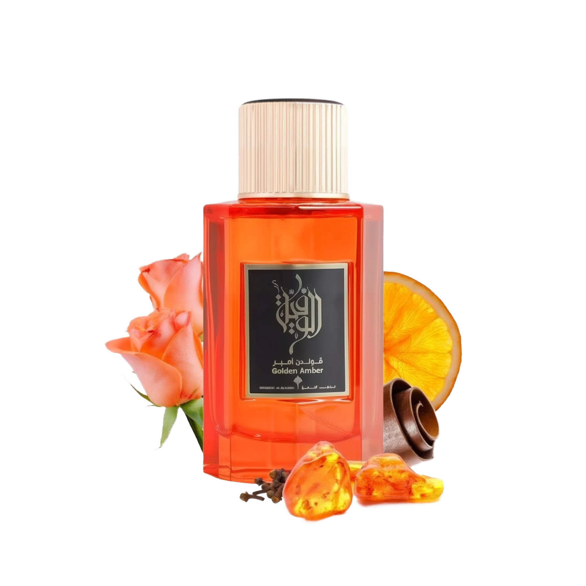 This is an image of a rectangular, transparent orange bottle of perfume labeled "Golden Amber" by Ibraheem Al Qurashi. The perfume bottle has a white cap and features black Arabic calligraphy on the label. Beside the bottle, there's a peach-colored rose, a slice of dried orange, a few cloves, and some pieces of amber resin, all placed against a white background. 