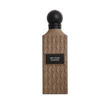 Brown geometric perfume bottle with black round cap and a label reading “Grey Pearl Diamond”.