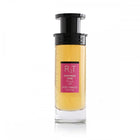 This is an image of a cylindrical clear perfume bottle with a black top and pump. The perfume has a yellow tint and features a pink label with the initials "RT" in large letters, the phrase "HAPPINESS DOSE" in smaller letters, both in English and Arabic, and "ROSE TOBACCO" underneath. The bottle is showcased against a plain white background, focusing on the simplicity and elegance of the design.