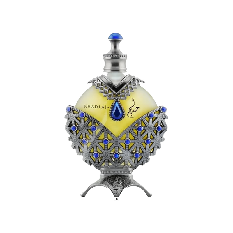A luxurious perfume box and bottle from the brand Khadlaj, named Hareem Al Sultan Blue. The box is designed with intricate silver and blue patterns, featuring an ornate design that exudes elegance and sophistication. The perfume bottle is shaped like a teardrop and embellished with detailed silver and blue decorations.  The bottle has a prominent blue jewel at its center and is topped with a silver cap adorned with a blue gem.