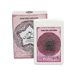  The image shows a product from the "OUD COLLECTION" named "HAREEM AL SULTAN." It includes a pink and white box with intricate lace-like patterns and Arabic calligraphy, alongside a matching white plastic container with a clear window that displays a smaller item inside, possibly a perfume bottle. Both the box and the container feature the same design elements and mention "Eau de Parfum Natural Spray" and the volume "20ml 0.68 FL.OZ." 