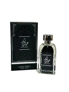 A bottle of Hayaati perfume by Lattafa next to its packaging box. The perfume bottle is clear with a black label featuring the Hayaati logo in white Arabic calligraphy. The box is black with a textured design, silver accents, and the same logo as the bottle.
