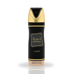 A tall, slim cylindrical body spray can in matte black with metallic gold accents. The gold cap curves into a black spray nozzle, and two thin gold bands encircle the can near its top and bottom. Centered on the body is a gold‑outlined square containing Arabic script “خمرة” above the English name “KHAMRAH,” with the brand name “Lattafa” printed beneath.