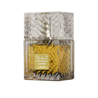 This image presents a close-up of a square perfume bottle from Lattafa, named "KHAMRAH QAHWA". The glass bottle has a detailed, faceted design that gives a sense of luxury and complexity. The perfume liquid inside is a deep, golden yellow, suggesting a rich and possibly warm scent. The bottle has a clear glass cap that matches the overall design. On the front of the bottle, there is a rectangular, golden label with the perfume's name "KHAMRAH" and "QAHWA" below it, as well as the brand name "Lattafa".