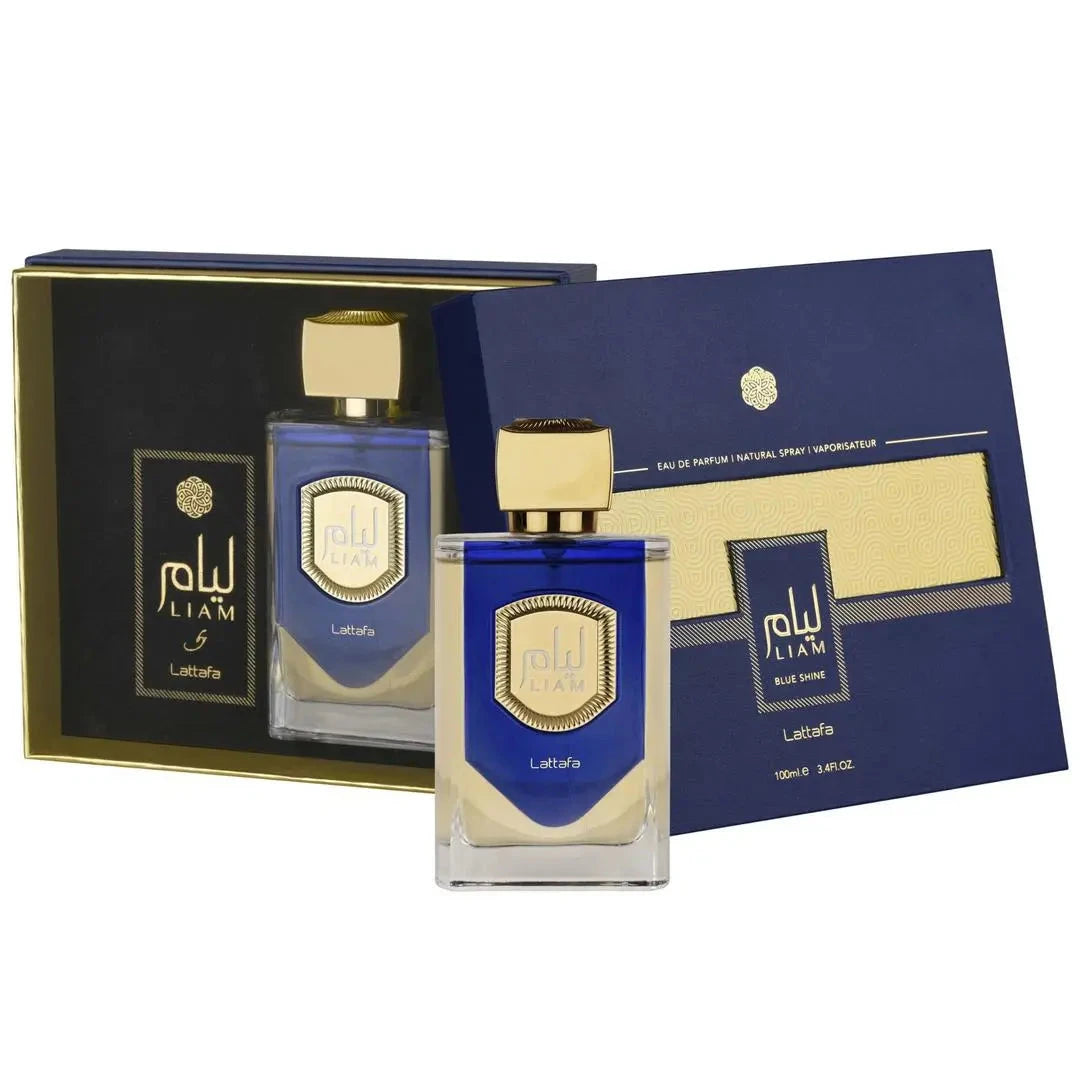 The image showcases a set of Liam Blue Shine perfume by Lattafa. In the foreground, there's a rectangular glass perfume bottle with a blue gradient design and a gold label featuring the brand name "Liam" in a stylized font. The cap is a solid gold color with a textured look.  An identical, smaller bottle is also visible inside the opened box, set against a black interior background with a gold design, reflecting the brand's luxurious aesthetic. 