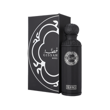 A sleek, cylindrical black perfume bottle with an ornate spherical cap, labeled “Gissah Mavro” in silver, standing next to a matching black box adorned with a stylized silver pattern.