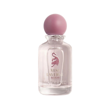 Miss Laverne Bloom perfume bottle in clear glass with a soft pink round cap.