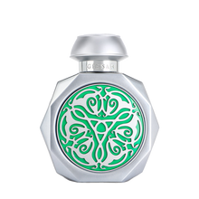 Silver perfume bottle with green decorative emblem.