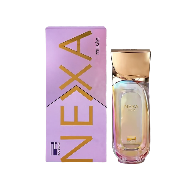 The image shows a bottle of "Nexa Musee" perfume next to its packaging. The bottle has a simple, elegant design with a golden cap, and the glass is slightly iridescent, reflecting subtle colors. The packaging is a lavender box with the name "NEXA" in bold, stylized letters in a gold color. The text "musee" is smaller and located below the brand name. The label "Rue Broca" is featured at the bottom of the box in a smaller font.