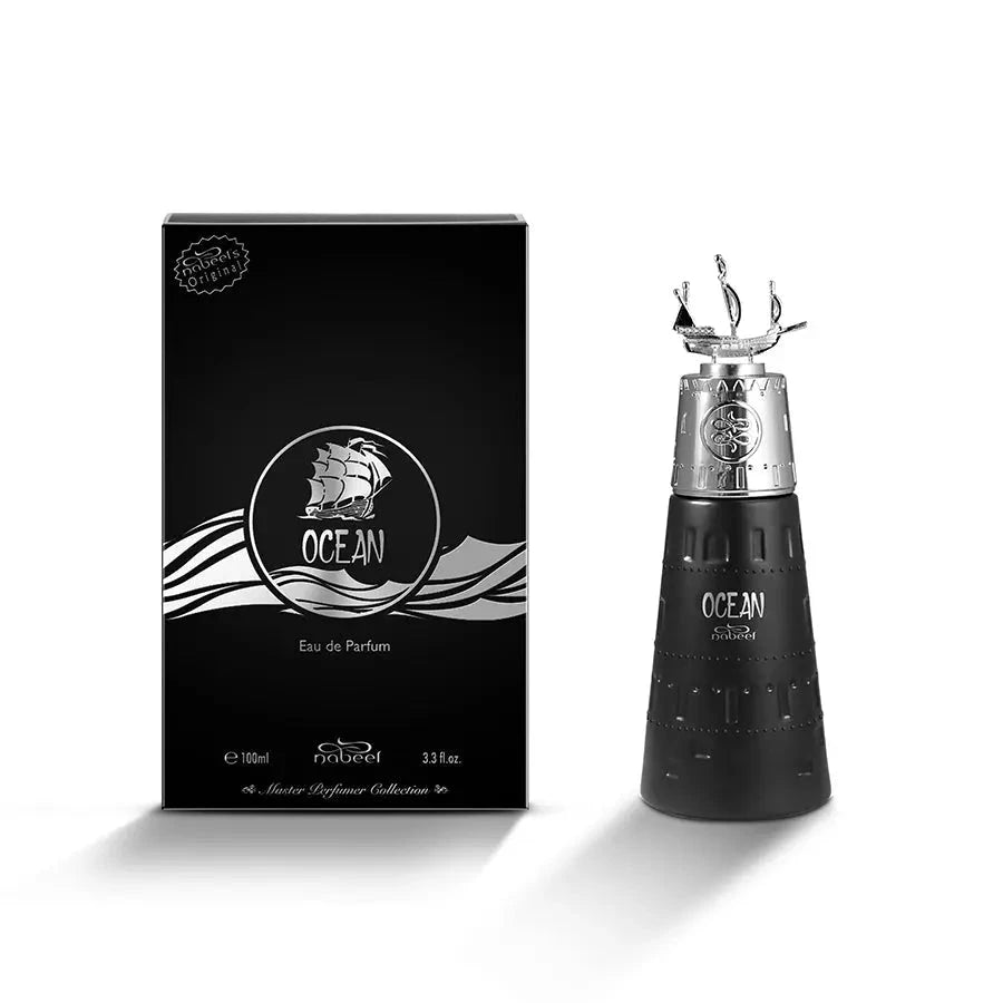 This image displays a black, designer fragrance product with its packaging. On the left, there's a black box with "OCEAN Eau de Parfum" written on it, featuring a circular logo with a stylized ship on waves. The text also includes "100ml, 3.33fl.oz," and "Nabeel's Master Perfume Collection." On the right, matching the perfume bottle from the  previous image, it is black with a textured surface and a silver cap featuring a small silver ship sculpture.