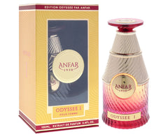 A decorative perfume gift set box next to a conical, gold-trimmed glass bottle that fades from deep red at the base to creamy ivory at the top, featuring the brand “ANFAR 1950” and the label “Odyssée I Pour Femme.