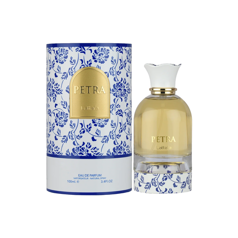 Lattafa Petra perfume bottle with white cap beside floral blue and white patterned cylindrical box.