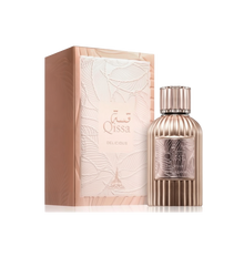 A round metallic perfume bottle with vertical ridges, labeled “Qissa Delicious,” featuring a matching ridged cap, standing beside a pale pink box with an embossed leaf design.