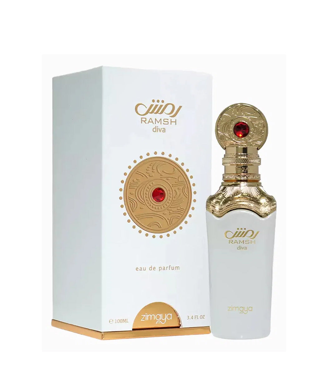 A bottle and packaging of Ramsh Diva Eau De Parfum by Zimaya. The perfume bottle is sleek and white with a gold ornate neck and cap, featuring engraved patterns and a striking red gemstone-like accent. The front label reads "RAMSH diva" and "zimaya" in gold lettering. The matching white box includes a gold circular emblem with red detailing and the same branding, with gold edging along the bottom. The design conveys elegance, luxury, and a regal feminine touch.