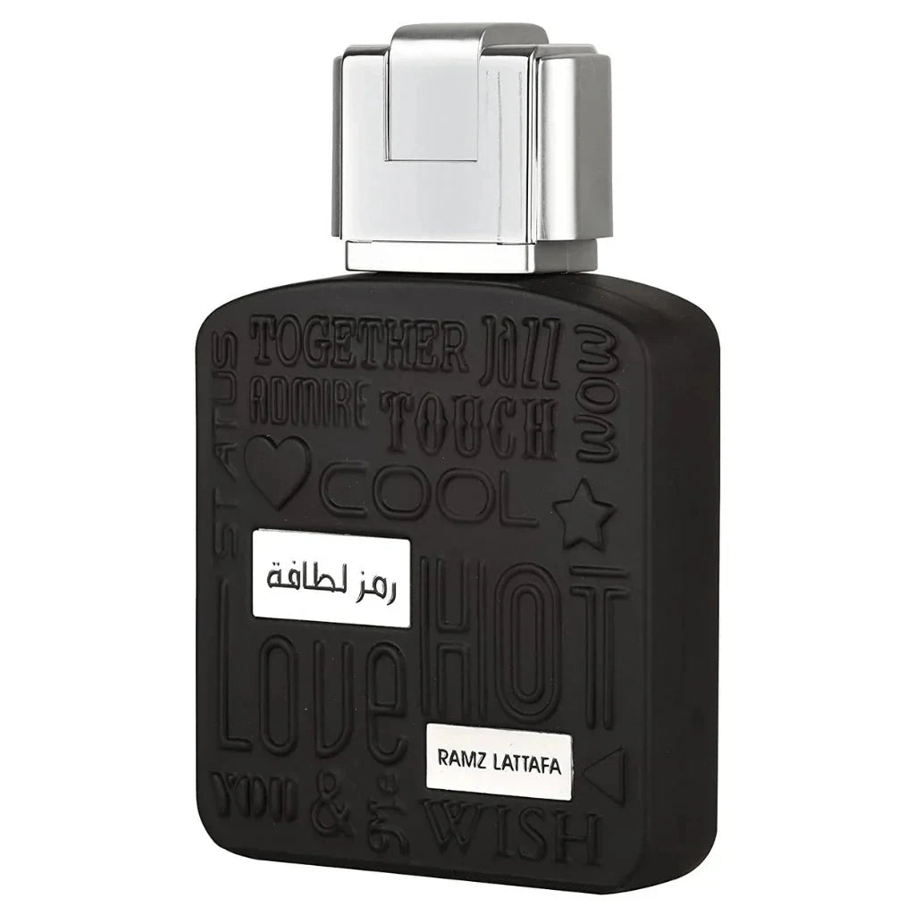 A close-up of the black bottle of "Ramz Lattafa" Eau de Parfum. The bottle's design includes embossed words like "Together," "Jazz," and "Touch" in varying styles. A metallic silver cap is on top of the bottle, and the product name is displayed in both Ar