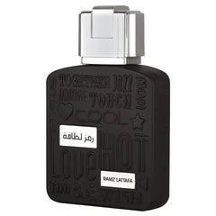 A close-up of the black bottle of "Ramz Lattafa" Eau de Parfum. The bottle's design includes embossed words like "Together," "Jazz," and "Touch" in varying styles. A metallic silver cap is on top of the bottle, and the product name is displayed in both Ar
