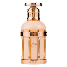 Elegant beige and gold perfume bottle with ornate metallic frame and Reham Paris Corner branding.