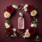 Rouat Al Musk French Hair Mist bottle centered, framed by red and cream roses, jasmine flowers, vanilla, and oud wood.