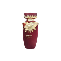 The image shows a perfume bottle from the brand Lattafa, specifically the "SAKEENA" fragrance. The bottle is maroon with a tapered shape and features a golden, ornate lid that resembles a crown, complete with a gemstone accent in the center. The design elements suggest a luxurious and exotic scent. "SAKEENA" is written in gold Arabic calligraphy on the body of the bottle, which is set against a plain background, emphasizing the bottle's elegant design and rich color palette.