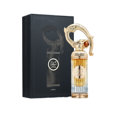 A luxurious bottle of Sehr Lattafa perfume by Lattafa, positioned beside its elegant black box. The tall, ribbed glass bottle transitions from clear at the base to a golden amber hue at the top. The centerpiece is an ornate, sculpted gold cap resembling an Arabian dagger or sword hilt, adorned with intricate detailing and a gemstone-like accent. The circular gold label on the front displays the name 'Sehr Lattafa' in Arabic and English.