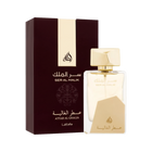 The image shows a clear perfume bottle from Lattafa with gold accents and the name "Ser Al Malik" in both Arabic and English. The bottle features a unique design with a large geometric gold cap and a matching gold label at the bottom. The text "Attar Al G