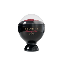 A glossy black, spherical perfume bottle labeled “Souvenir Blooming Bliss” by Afnan, topped with a transparent dome showcasing sculpted red roses underneath.