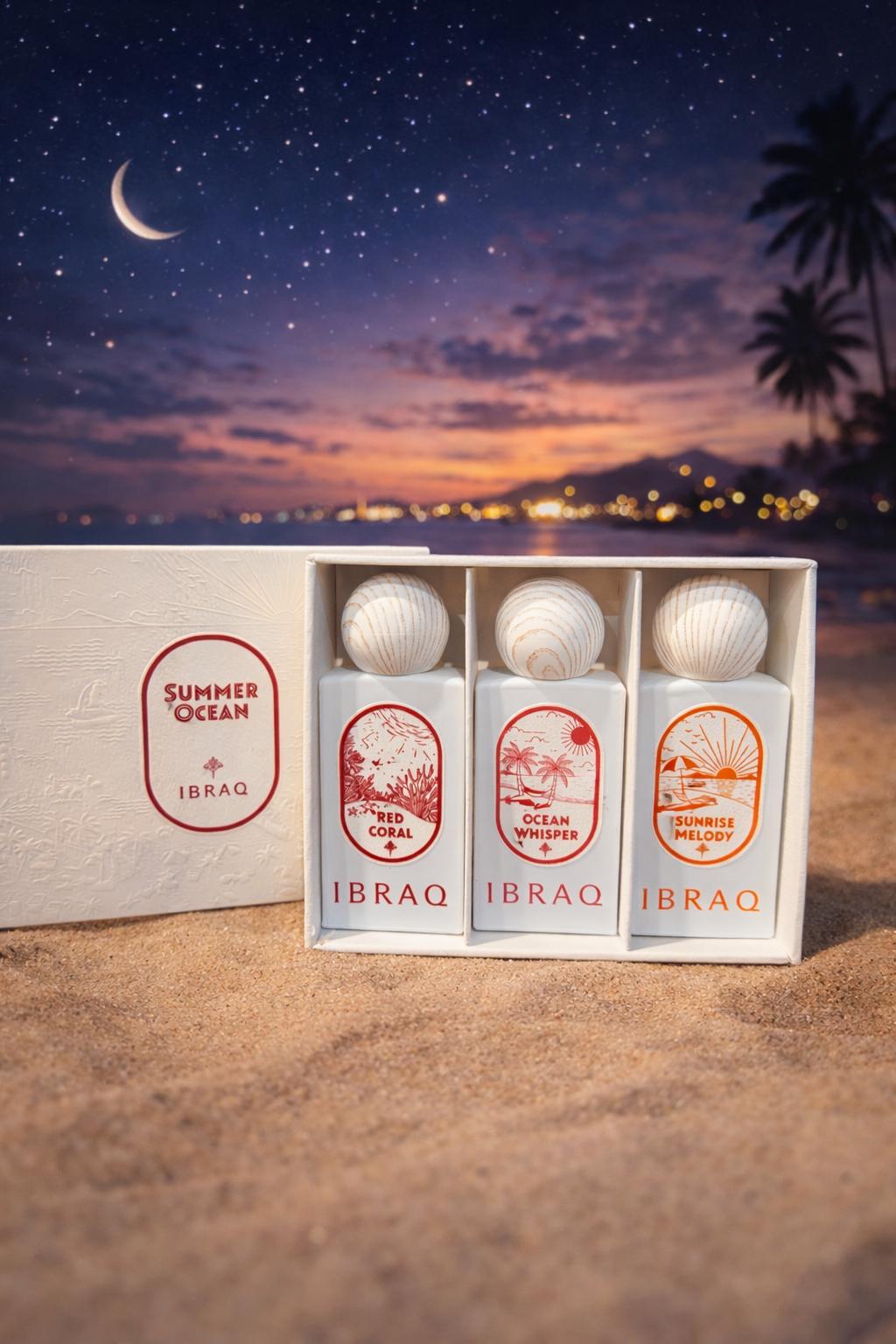 Summer Ocean gift set of three white perfumes with wooden caps rests on sand under a starry twilight sky.